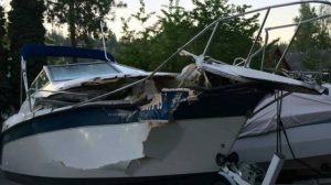 You are caught in severe weather while boating. Where should you seat your passengers?